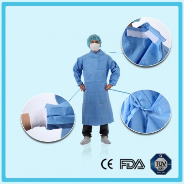 Disposable nonwoven reinforced surgical gown with raglan sleeves